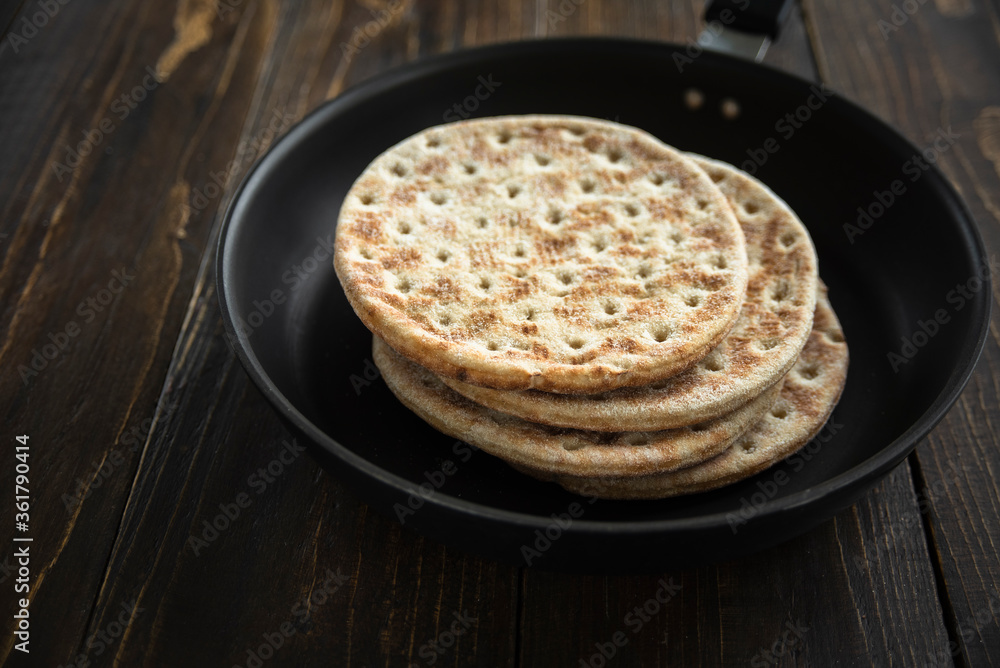 Stack of soft unleavened flatbread on pan Stack of soft unleavened flatbread on pan