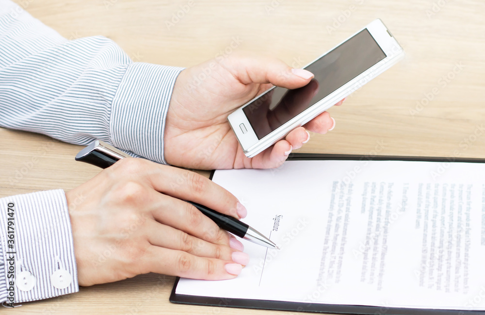 Businessman signs a contract at the table. Business Businessman signs a contract at the table. Business