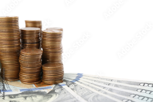 Dollar bills and coins on white background