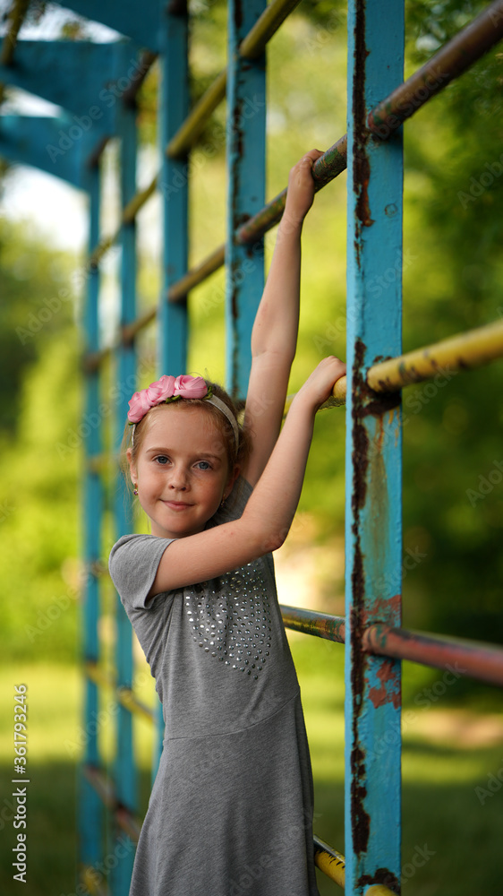 Portrait of cute little girl in grey dress posing on sport staircase Portrait of cute little girl in grey dress posing on sport staircase