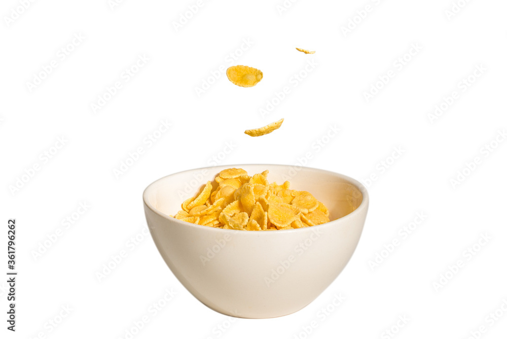 Corn flakes falling to the white bowl. Motion. Corn flakes falling to the white bowl. Motion.