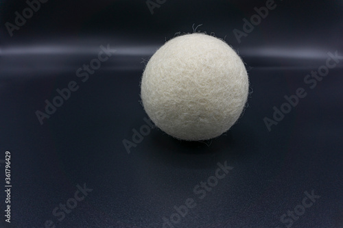 Reusable wool dryer ball as a fabric softener  isolated on gray background