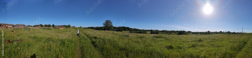 Panorama of the rural landscape, against the bright sun and clear blue sky Panorama of the rural landscape, against the bright sun and clear blue sky