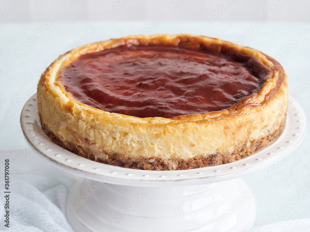 whole cheese cake with strawberry jam on top whole cheese cake with strawberry jam on top