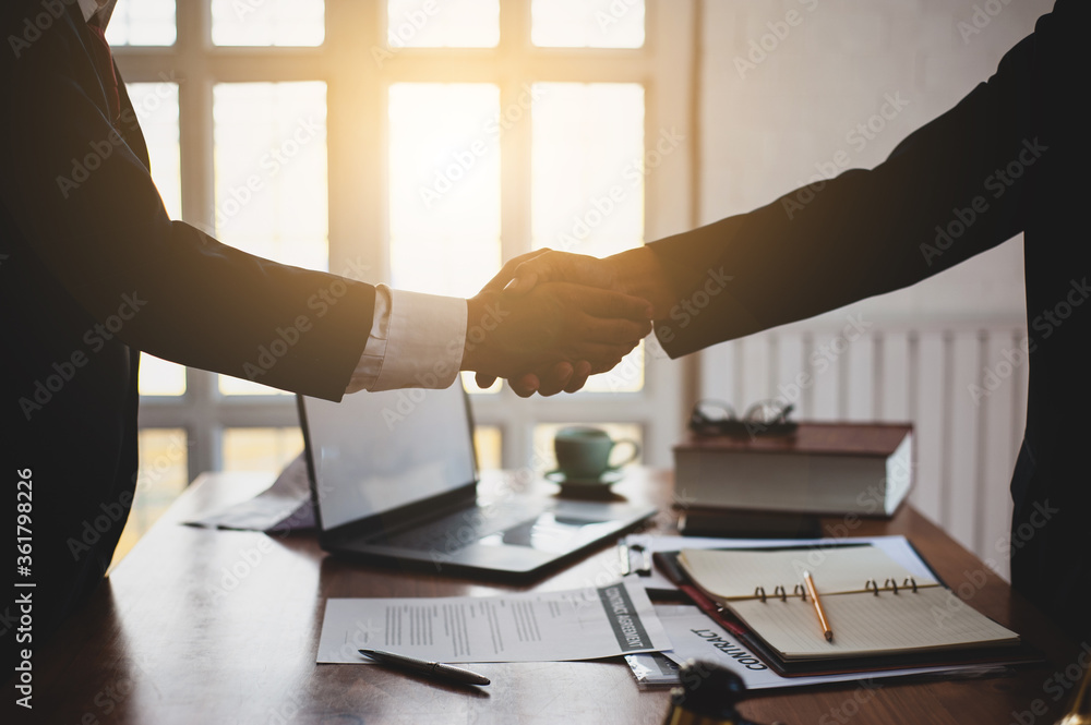 Business people shake hands after signing contract agreement. Business people shake hands after signing contract agreement.