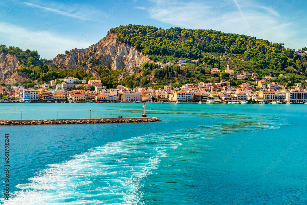 Amazing view leaving the port of Zakynthos on a summer day !!!  A cityscape view from the sea where the amazing turquoise waters make an amazing contrast  to the green of the mountain !!!