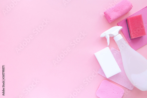 Cleaning products agent, sponges, napkins and rubber gloves, pink background. Top view. Copy space