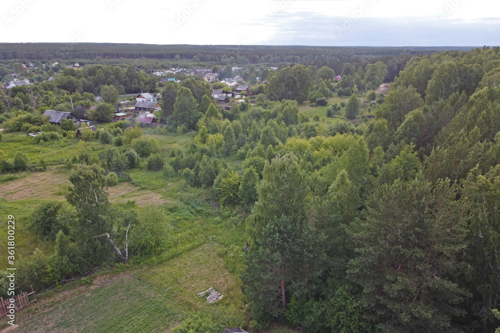 View on a summer evening on the outskirts of a small town surrounded by forests View on a summer evening on the outskirts of a small town surrounded by forests