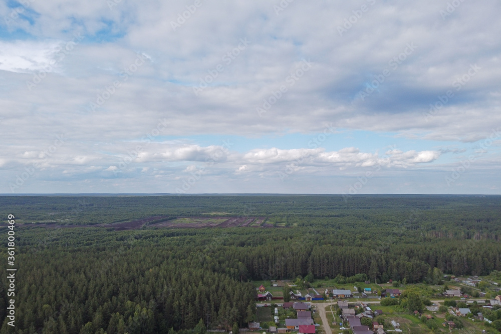 Beyond the edge of the small town you can see endless coniferous forests