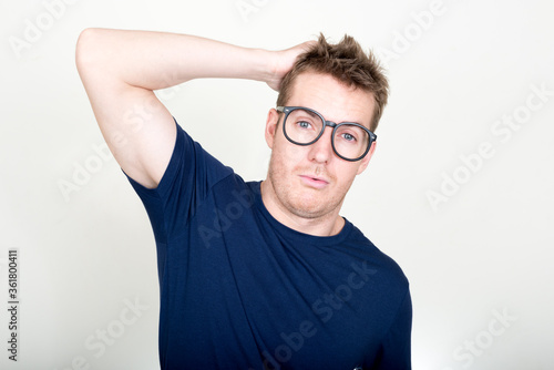 Portrait of handsome man with eyeglasses looking confused © Ranta Images