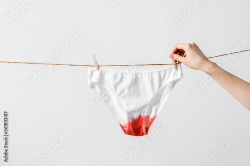 Fotografija Woman hangs underwear on clothesline, concept content for feminist blog, poster
