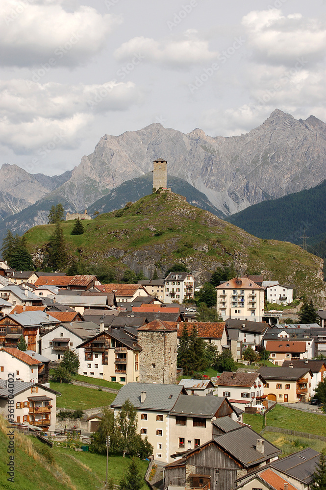 Small Ardez village, Scuol municipality, with the Swiss Alps and the ancient ruins of the Medieval Castle Steinsberg. Engadin valley, Graubunden canton, Switzerland, Europe