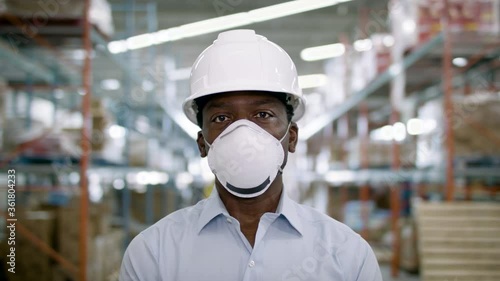 A wearhouse manager in a mask. Supply chain safety. Back to work. Shot in 4k.  photo