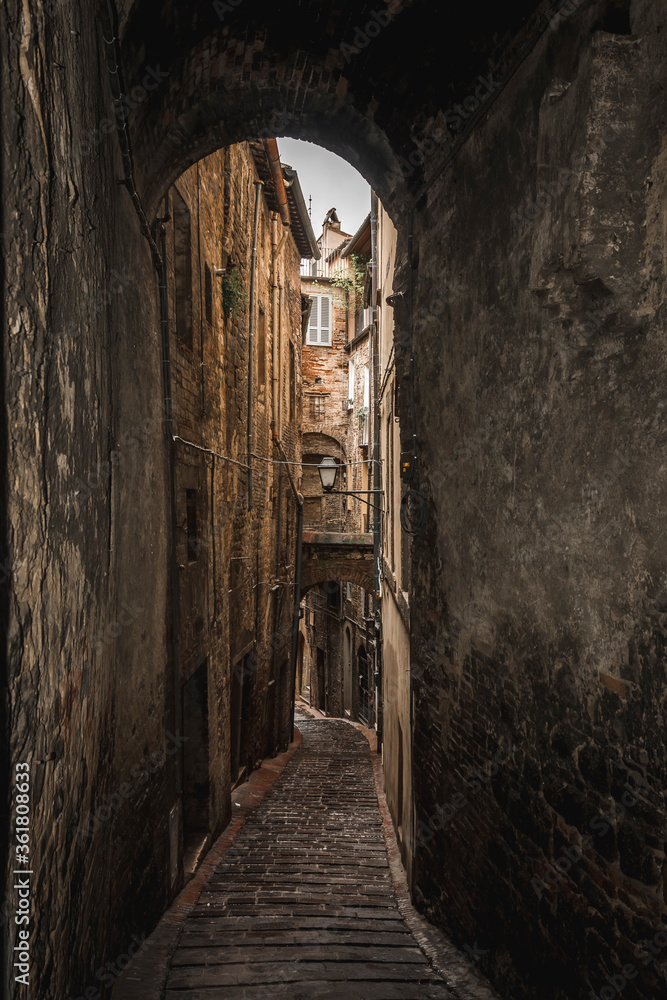 Obraz premium one of the many alleys of the historic center of Perugia with typically medieval tones