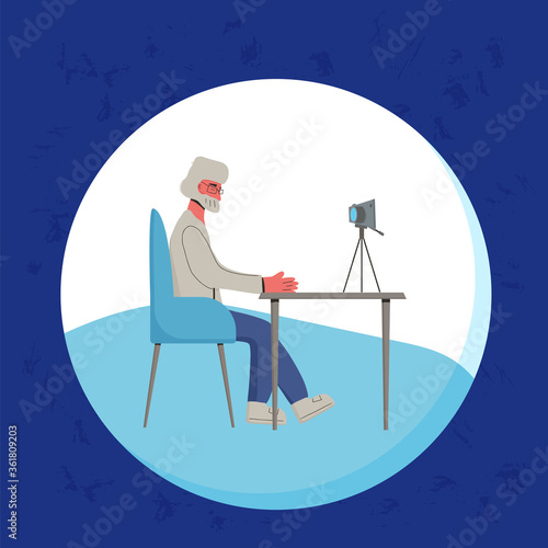 Senior blogger recording a new content. Mature man in front of the camera.