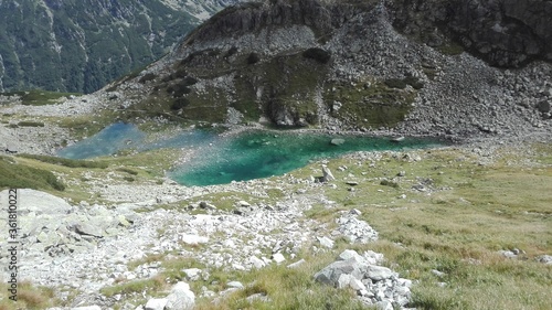 Small silent clear lake, see-through water in the mountains.