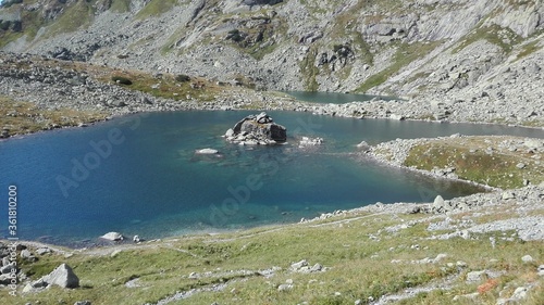 Crystal clear lake in mountains with small island