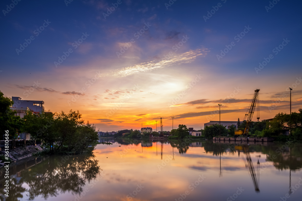 Hai Phong, Vietnam  Sep 2015 sunset at Tam Bac river bank with mirror water surface 