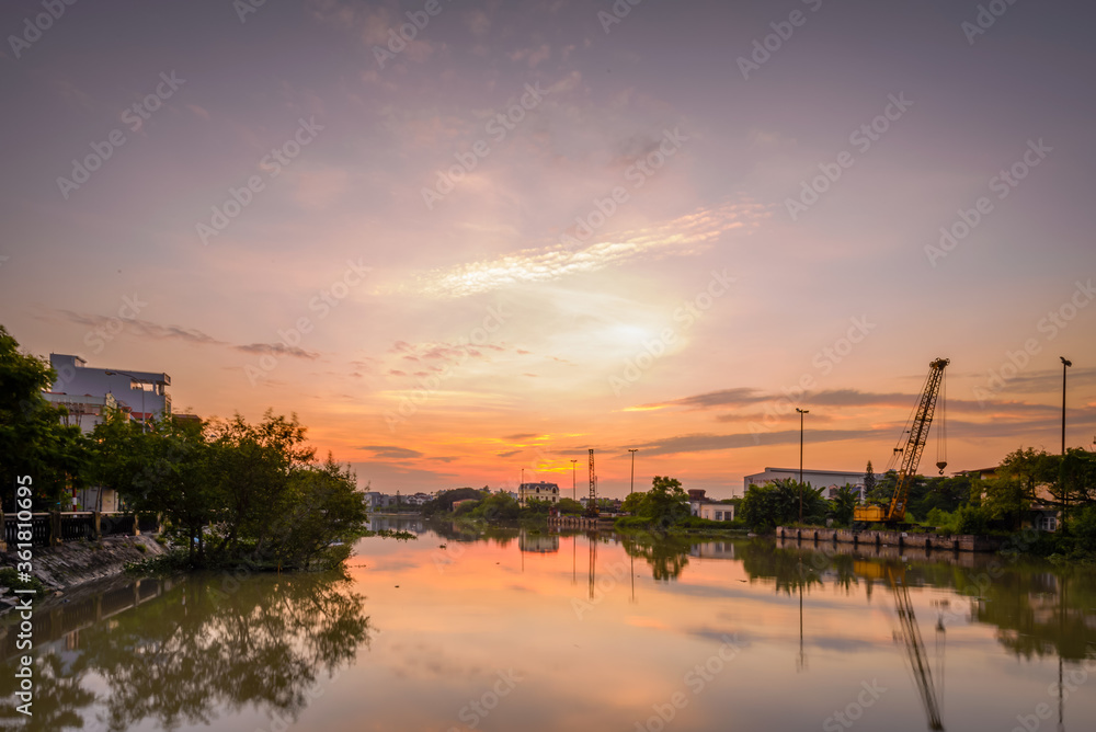 Hai Phong, Vietnam  Sep 2015 sunset at Tam Bac river bank with mirror water surface 