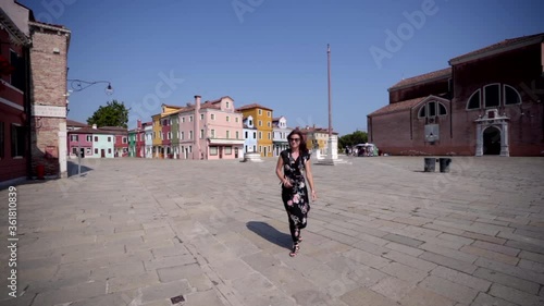 Wallpaper Mural Young attractive woman walking and smiling surrounded by colorful buildings. Venice Burano Italy Torontodigital.ca