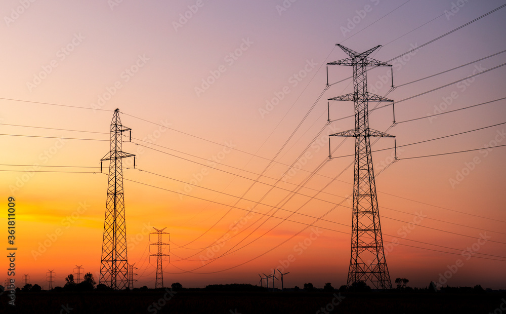 Electric pole over sunrise sky background