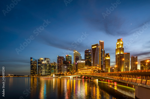 Singapore 2019, iconic view from Singapore river to Marina Bay Sands and Central Business District. Blue hour reflection on the water during sunrise sunset © Huntergol