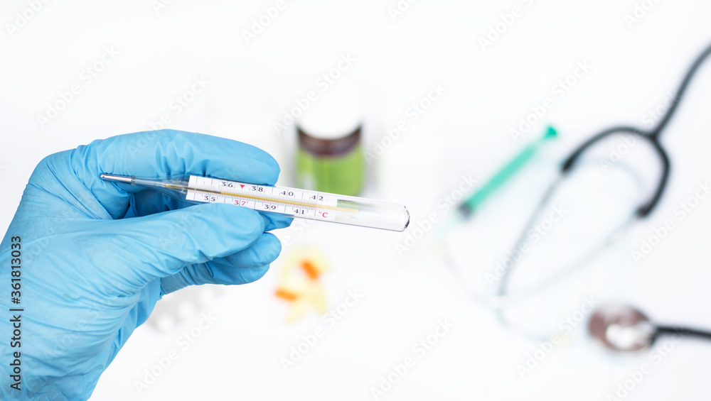 thermometer in the hands of a doctor. Treatment concept thermometer in the hands of a doctor. Treatment concept