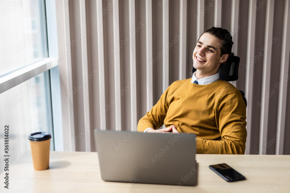 A time for relax. Young, happy businessman is relaxing in his office. A time for relax. Young, happy businessman is relaxing in his office.