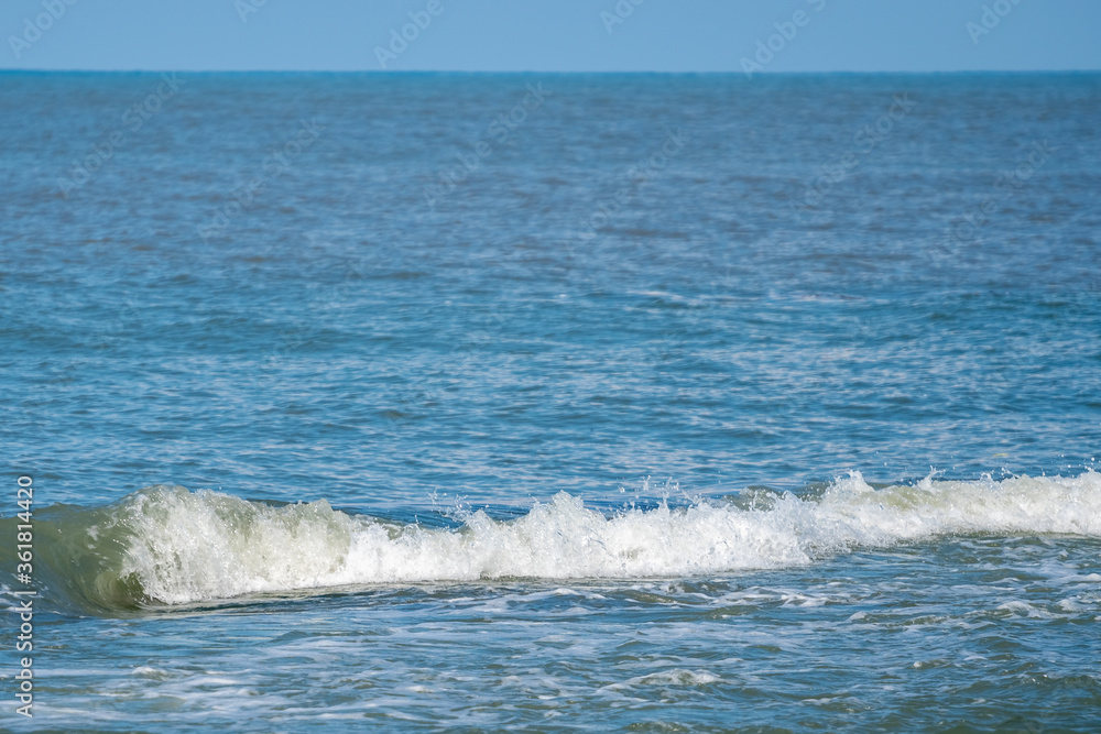 Small waves on the sea coast, beautiful blue sea