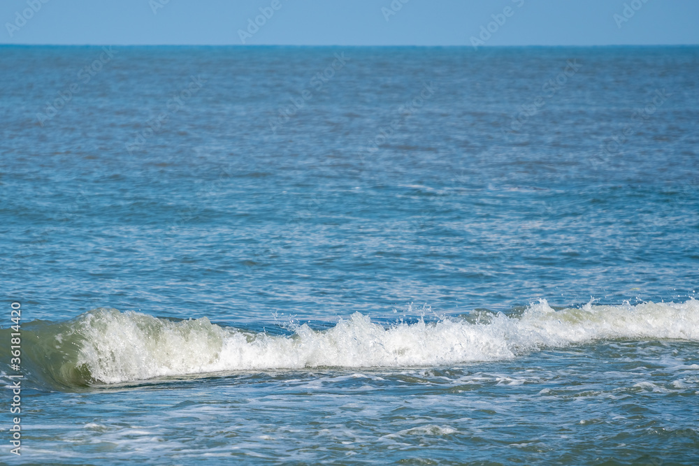 Small waves on the sea coast, beautiful blue sea Small waves on the sea coast, beautiful blue sea