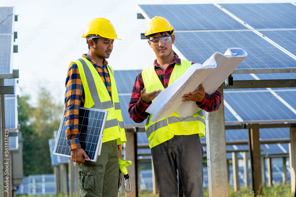 Engineer working on checking equipment in solar power plant,Climate change and renewable energy concept. Engineer working on checking equipment in solar power plant,Climate change and renewable energy concept.
