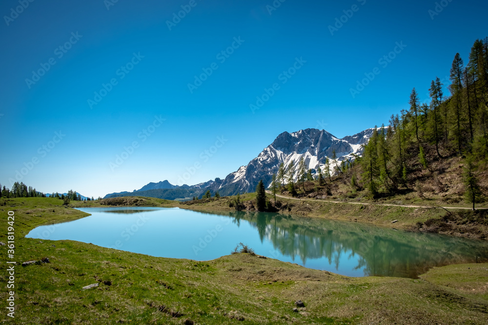 Calm lake in a sunny day in the beautiful Carnic Alps, Friuli-Venezia Giulia, Italy Calm lake in a sunny day in the beautiful Carnic Alps, Friuli-Venezia Giulia, Italy