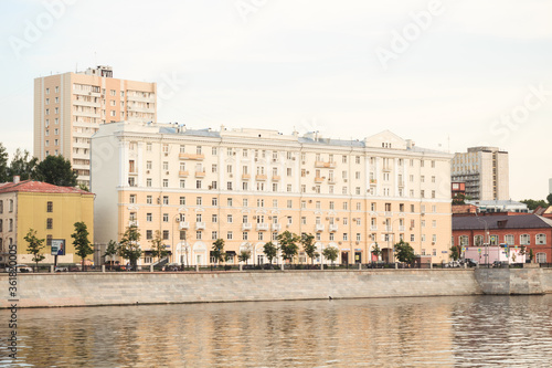 Moscow, Russia - June 9, 2020: Buildings on Savvinskaya embankment in summer. Stalin's architecture beside the Moscow river.
