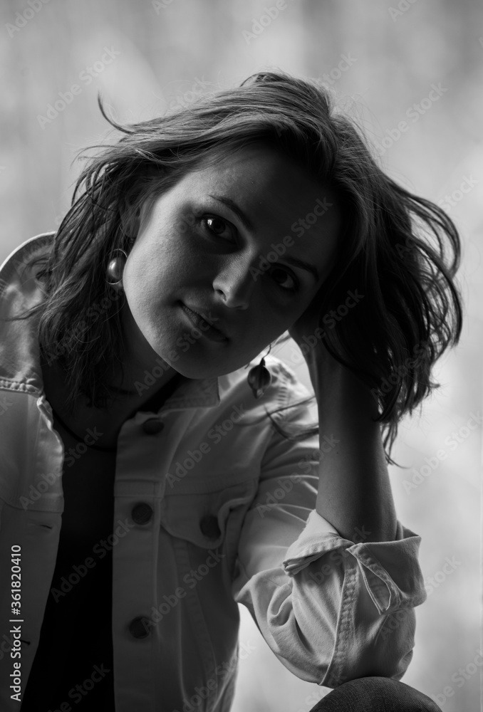 Nice black and white close up portrait of young woman with emotions on face in day light Nice black and white close up portrait of young woman with emotions on face in day light