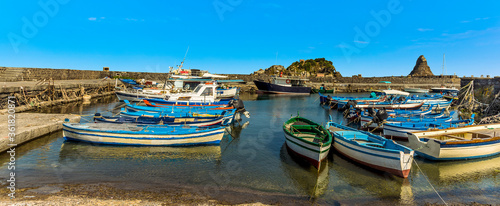 Fishermen's boats in the harbour at Aci Trezza, Sicily against a background of Isole dei Ciclopi in summer