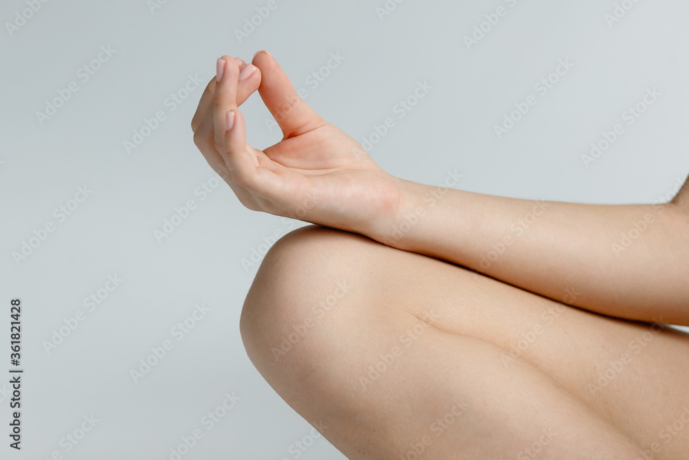 Close-up of man meditating. Female hand showing yoga or meditation gesture - obrazy, fototapety, plakaty 
