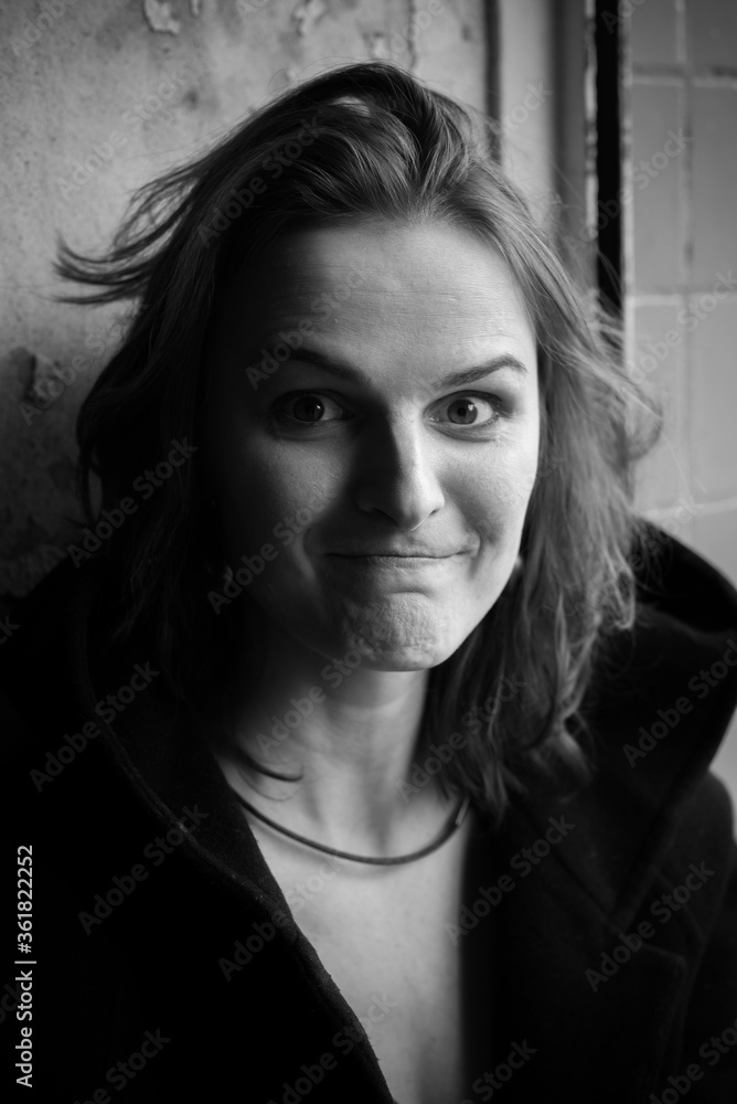 Nice black and white close up portrait of young woman with emotions on face in day light Nice black and white close up portrait of young woman with emotions on face in day light
