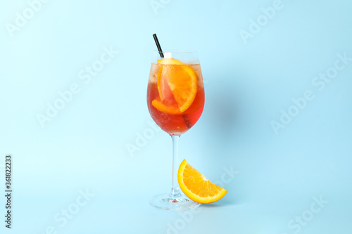 Aperol spritz cocktail on blue background. Summer drink