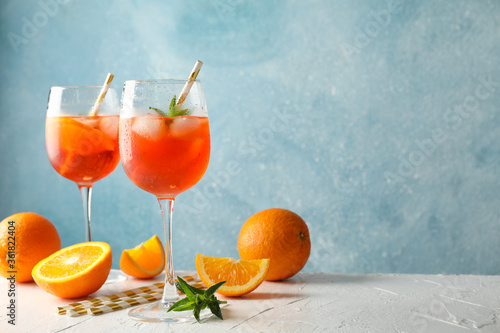 Composition with aperol spritz cocktail against blue background