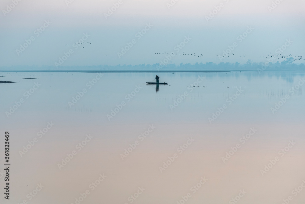 A fisherman fishing alone early in the morning at Zumpango Lake, Estado de México, Mexico.