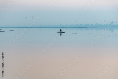 A fisherman fishing alone early in the morning at Zumpango Lake, Estado de México, Mexico.
