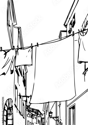Clothes on clothesline in a narrow lane street