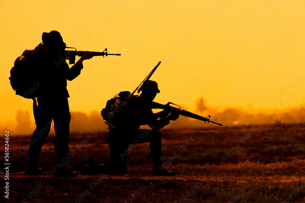 Team special forces. soldier assault rifle with silencer.Silhouette action soldiers hold weapons.military and danger concept. Team special forces. soldier assault rifle with silencer.Silhouette action soldiers hold weapons.military and danger concept.