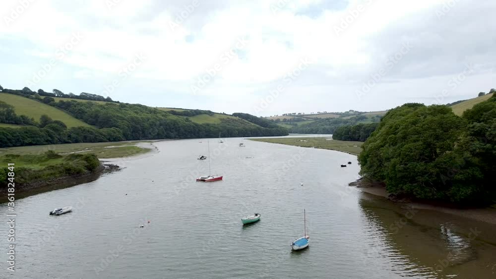 high to low drone shot traveling backwards down a river to reveal to people kayaking down the estuary. high to low drone shot traveling backwards down a river to reveal to people kayaking down the estuary.