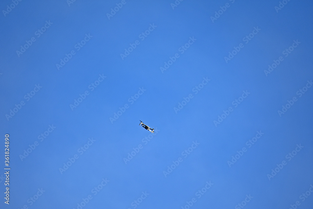 Drone flying against blue sky