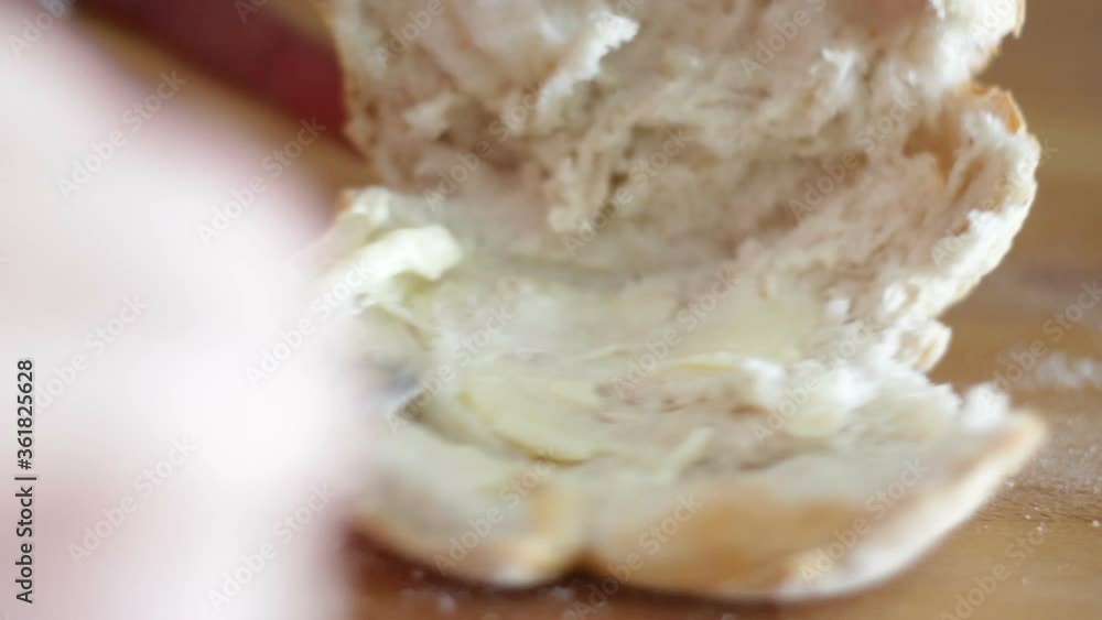 Woman hands spreading butter on bread. Close-up Woman hands spreading butter on bread. Close-up