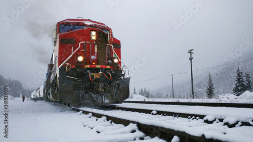 Photo Red Canadian Pacific train engine pulling cargo in the snow