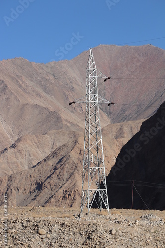 Electric pole in the middle of a deserted mountain landscape. photo