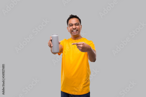 Indian man Pointing at Tin Can Isolated. Drink