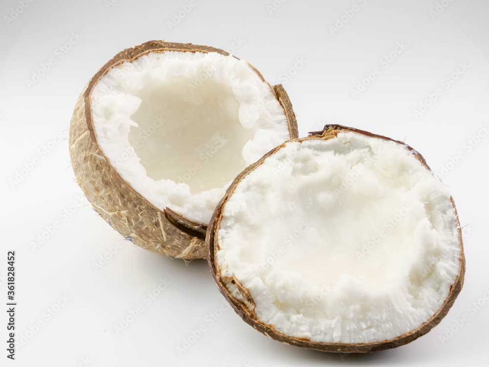 Coconut milk fruit halves split on background. Health Benefits Contains